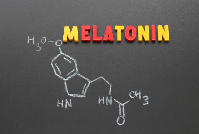 Chemical compound description of melatonin on blackboard