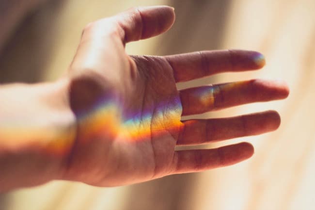 Rainbow reflected on human hand Rainbow reflected on human hand
